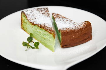 cheesecake green next to decorated with mint, on a black background