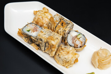 Sushi on a stone plate with black background