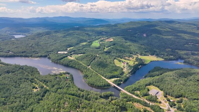 Pemigewasset River and New Hampton historic center aerial view from Hersey Mountain in summer, with White Mountain at the background, New Hampton, New Hampshire NH, USA. 