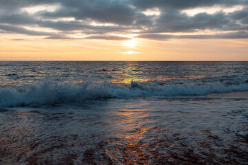 Natural landscape of beautiful sunset and waves of Mediterranean sea on coast of Cyprus.