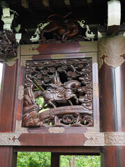 Close-up of the carved wooden mythical creatures on the Japanese gatehouse in Kew Gardens in London