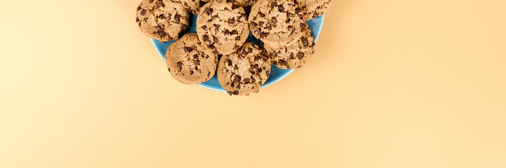 Plate of chocolate cookies, panoramic view, with copy space