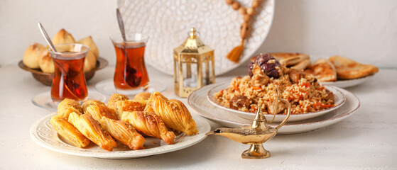 Traditional Eastern dishes with Aladdin lamps and tea on white table