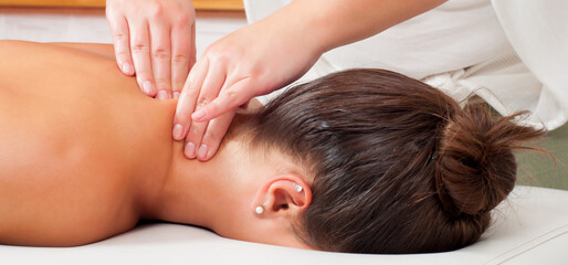 Girl getting back massage in massage salon, health spa