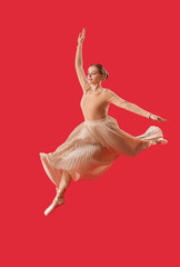 Naklejka premium Female ballerina jumping on red background