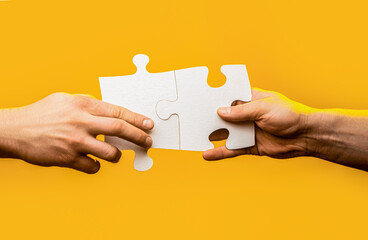 Hand connecting jigsaw puzzle. Business solutions, success and strategy concept. Man hands...