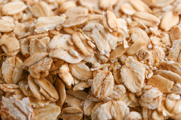 Raw oat flakes as background, closeup