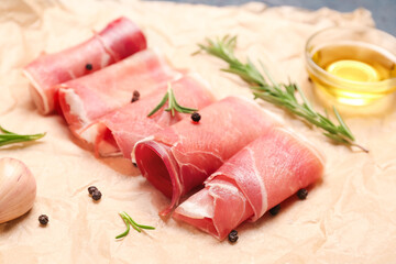 Baking paper with slices of tasty ham and spices, closeup