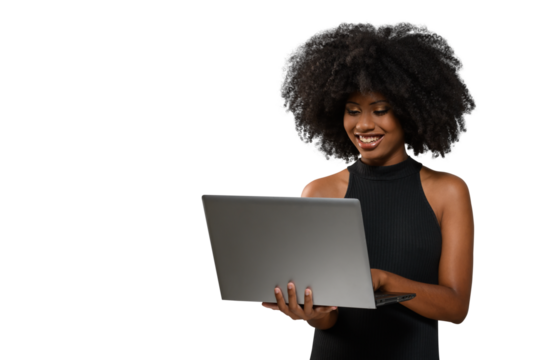 black woman holding a computer while looking and smiling at the computer screen