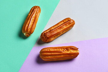 Sweet eclairs on color background