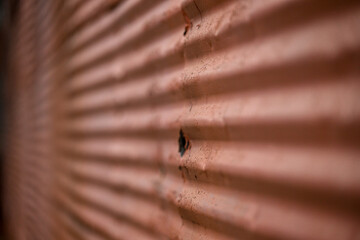Fototapeta na wymiar red textured corrugated metal wall on old factory,