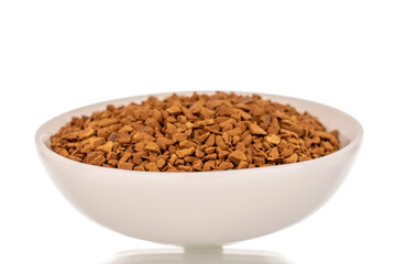 Fragrant instant coffee in a white ceramic saucer, macro, isolated on white background.