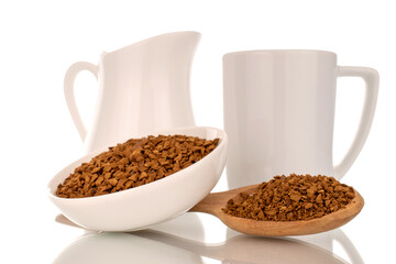 Fragrant instant coffee with wooden spoon and white ceramic dish, macro, isolated on white background.