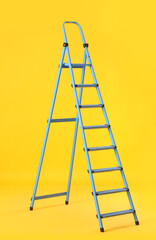 Maintenance ladder on yellow background