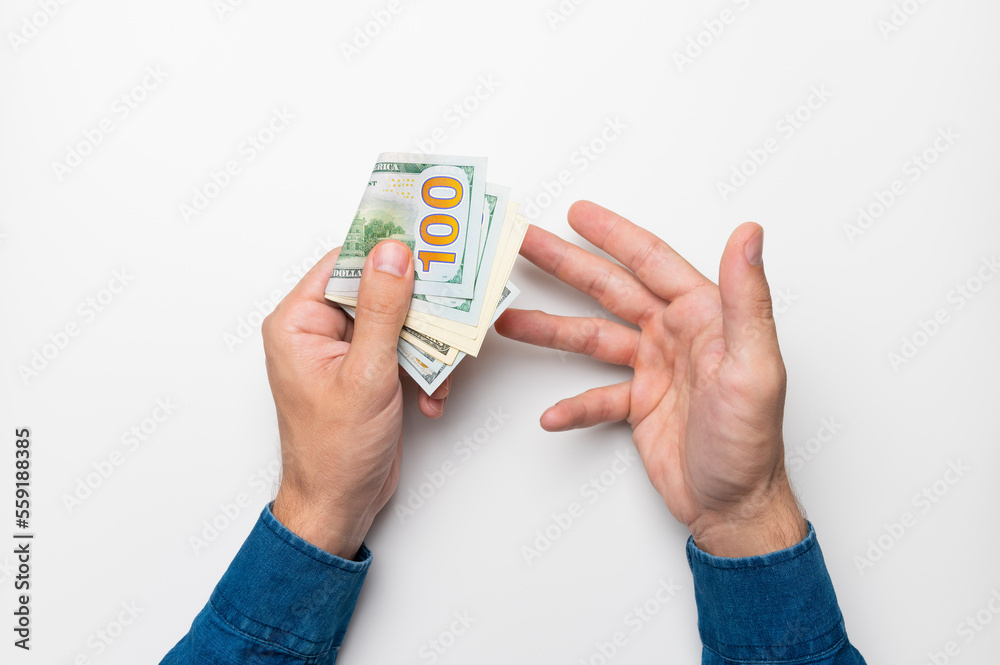 Wall mural businessman holding a stack of euro banknotes in his hand, points his finger at money, income, succe