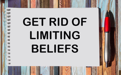 Get Rid Of Limiting Beliefs text quote on notepad, concept background