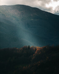 Single sun ray hitting the landscape during autumn © belminmesh