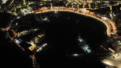 Fototapeta na wymiar Aerial drone night shot of illuminated recently renovated round port of Mikrolimano in the heart of Piraeus, Attica, Greece