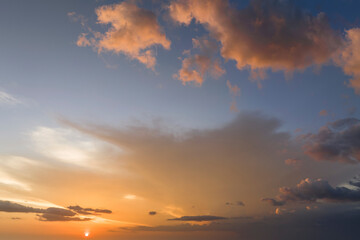 Colorful evening landscape with soft pastel coloured cloudscape on watercolor tinted sunset sky. Abstract nature background