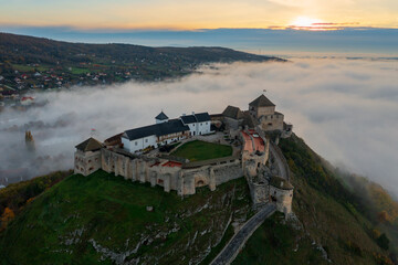 Aerial view about castle of Sumeg with foggy sunrise at the background.