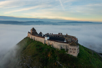 Fototapeta na wymiar Aerial view about castle of Sumeg with foggy sunrise at the background.