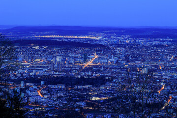 Swiss city Zürich in blue hours with the Zurich Airport at the far left above viewd from the Uetliberg