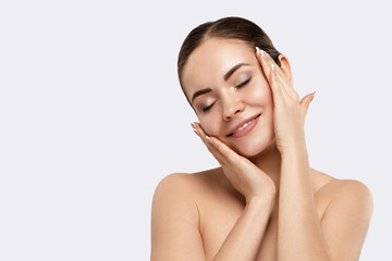 Beautiful Young Woman with Clean Fresh Skin touch own face. Facial  treatment. Skin care....