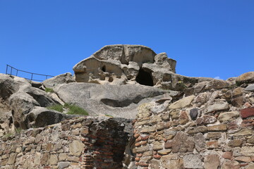 View of sandstone formation and cave town in ancient town Upliscikhe in region Georgia.