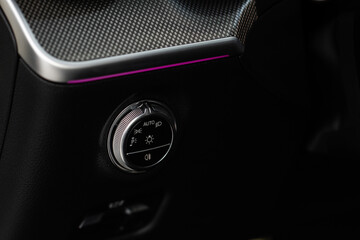 Closeup of the headlight switch control button. Lights control panel in car