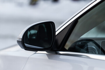 Rearview mirror of a modern white car.