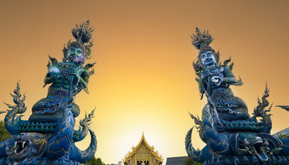 Wat Rong Seur Ten or Blue temple at sunset. Modern Buddhist temple distinguished by its vivid blue and yellow coloring elaborate carvings. Northern Thailand