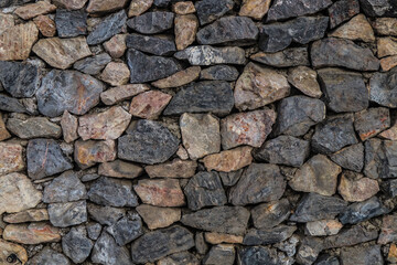 The texture of the stone wall. Old castle stone wall texture background. Stone wall as background or texture. Part of a stone wall for background or texture.