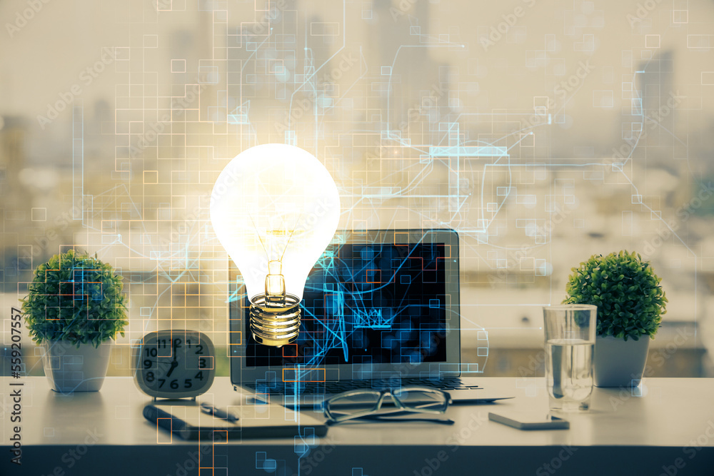 Poster Computer on desktop in office with bulb icon hologram. Double exposure. Concept of idea.