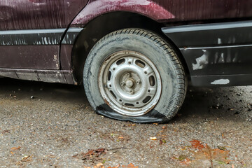 Flat tire of an old car close-up
