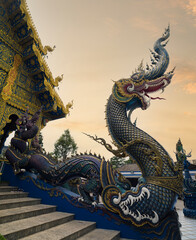 Fototapeta premium Wat Rong Seur Ten or Blue temple. Modern Buddhist temple distinguished by its vivid blue and yellow coloring elaborate carvings. Northern Thailand