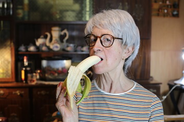 Senior woman eating a banana 