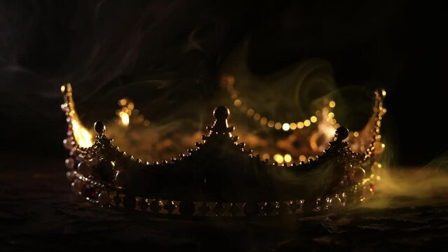 Fabulous golden crown of the king on a dark background. Panoramic view of the blue and red fog. Mockup for your logo. 