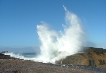 wave crashing over rocks