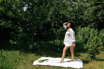  Happy Young Woman Sitting in the Grass Enjoining Nature. Carefree person resting in a countryside field experiencing mindfulness and calmness - 559213110