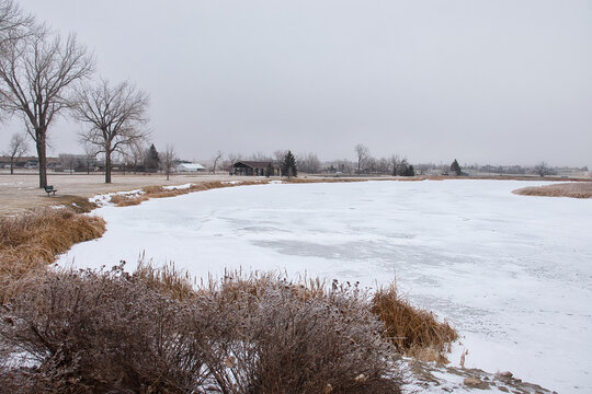 Frozen water at the fishing lake at Dalbey Memorial Park in Gillette, Wyoming on a cold winter day.