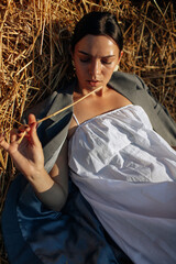 Beautiful hippie girl lying in a grass. Modern boho style. Beauty, fashion, - 559213531