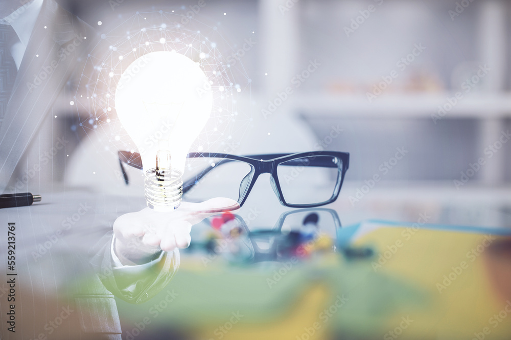 Poster bulb drawing with glasses on the table background. idea concept. double exposure.