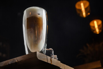 coffee drink with cream and ice on a dark wooden background
