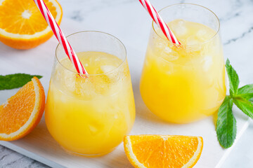 Obraz na płótnie Canvas Glass of orange juice with ice. Cold orange fresh