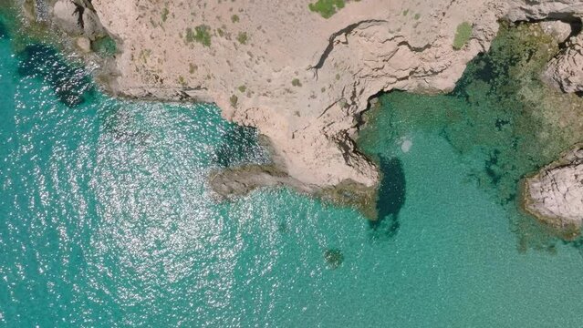 The rocky coast of Milos seen from above, Greece