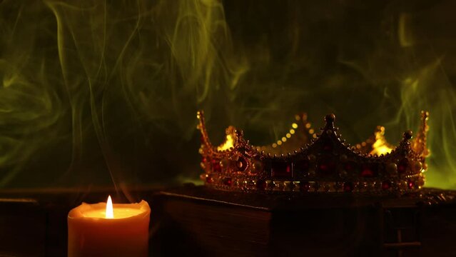 A golden crown, an old book, a key and old casket on a dark background. Panoramic view of the fog. Layout for your logo. A horizontal banner with a place to copy the cover image of a popular website.