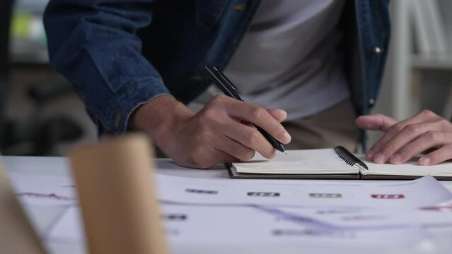 Graphic designer drawing sketches logo design. The concept of a new brand. Professional creative occupation with idea.