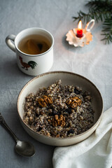 Kutia - essential traditional Ukrainian Christmas sweet dish prepared for Christmas Eve supper and cup of  uzvar on linen tablecloth.