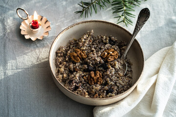 Kutia - essential traditional Ukrainian Christmas sweet dish prepared for Christmas Eve supper and cup of  uzvar on linen tablecloth.