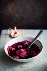 Bowl of traditional Ukrainian Christmas dish - borsch with vushka (porcini dumplings) prepared for Christmas Eve supper. 